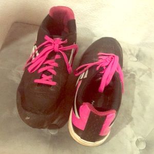 Pink and black softball cleats